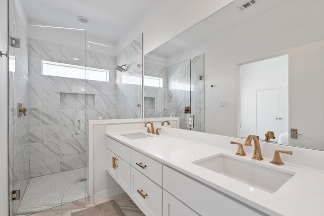 bathroom with a shower with door and vanity