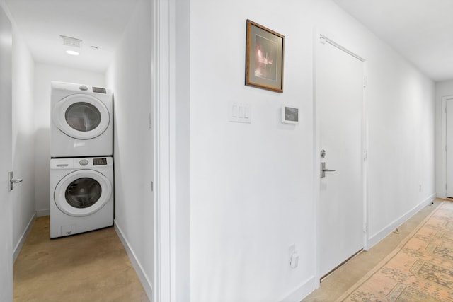 laundry area featuring stacked washer / dryer