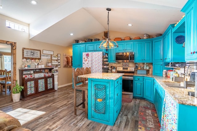 kitchen with blue cabinetry, sink, decorative light fixtures, appliances with stainless steel finishes, and a kitchen island