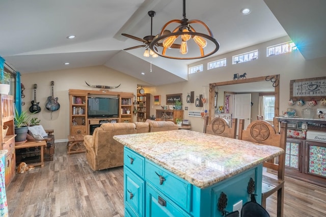 kitchen featuring blue cabinets, ceiling fan, light hardwood / wood-style flooring, and lofted ceiling