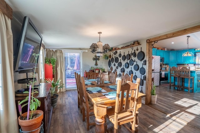 dining area featuring a chandelier and dark hardwood / wood-style floors