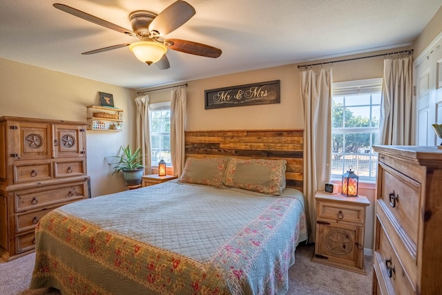 bedroom featuring multiple windows, carpet, and ceiling fan