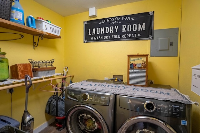 clothes washing area featuring electric panel and independent washer and dryer