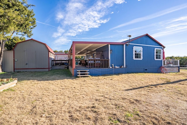 exterior space with a shed, a wooden deck, and a yard