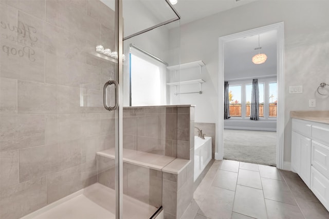 bathroom with shower with separate bathtub, vanity, and tile patterned flooring