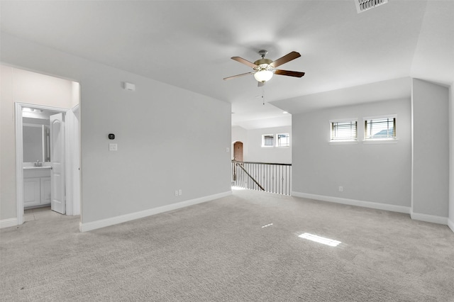 unfurnished room with light colored carpet and ceiling fan