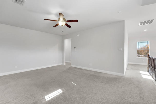 carpeted spare room with ceiling fan