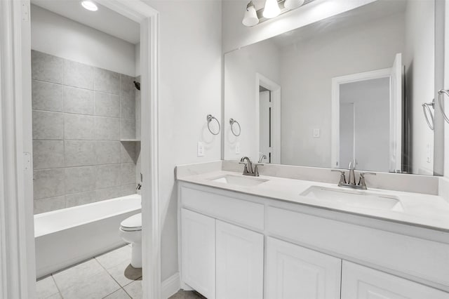 full bathroom featuring tiled shower / bath, tile patterned flooring, vanity, and toilet