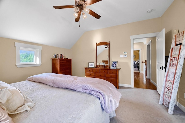 carpeted bedroom featuring ceiling fan and vaulted ceiling