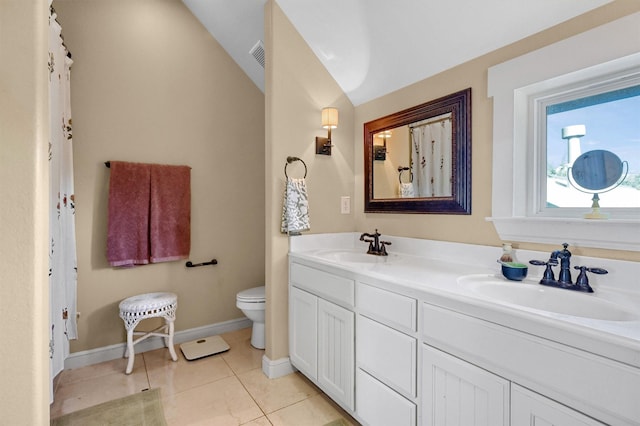 bathroom with vanity, lofted ceiling, tile patterned floors, and toilet