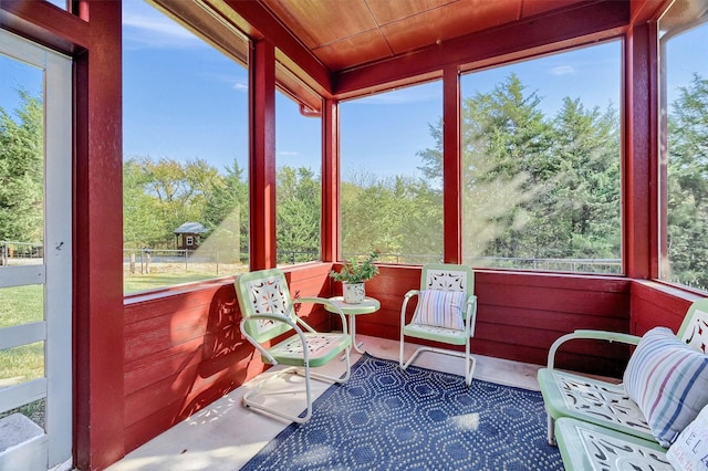 sunroom featuring wooden ceiling and plenty of natural light