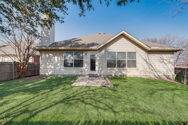 back of property with a patio and a lawn