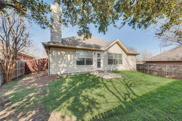 back of house featuring a patio and a yard