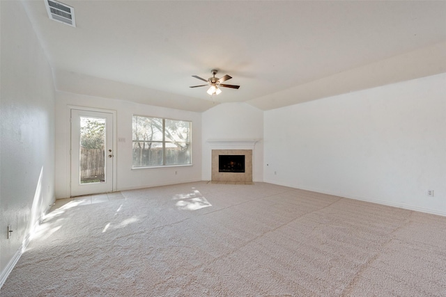 unfurnished living room featuring ceiling fan, light colored carpet, a tile fireplace, and lofted ceiling