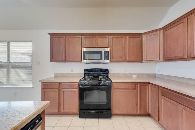 kitchen featuring appliances with stainless steel finishes and light tile patterned flooring