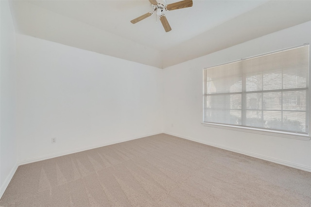 carpeted empty room with ceiling fan and vaulted ceiling