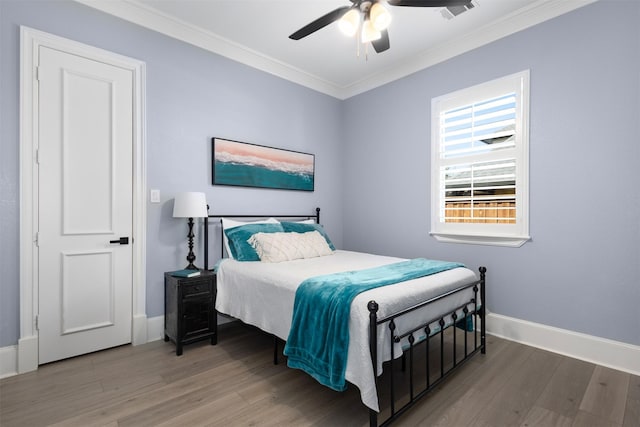 bedroom featuring ceiling fan, hardwood / wood-style flooring, and crown molding