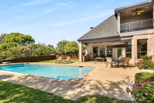 view of swimming pool featuring ceiling fan and a patio