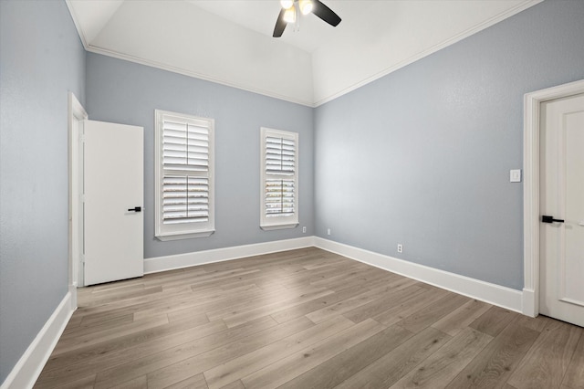 spare room with ceiling fan, ornamental molding, light hardwood / wood-style floors, and lofted ceiling