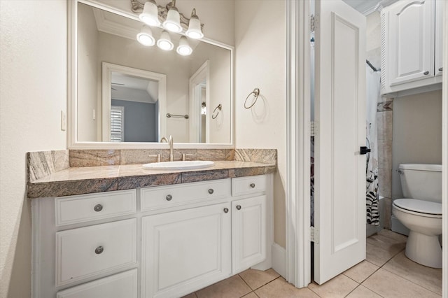 bathroom featuring toilet, tile patterned flooring, and vanity