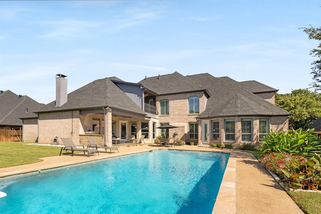 view of swimming pool with a patio area