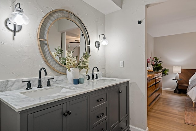 bathroom featuring vanity, hardwood / wood-style floors, and ceiling fan