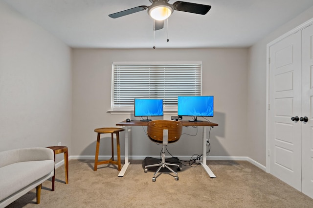 carpeted office space with ceiling fan