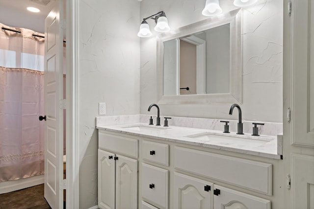 bathroom with a shower with shower curtain, vanity, and tile patterned flooring