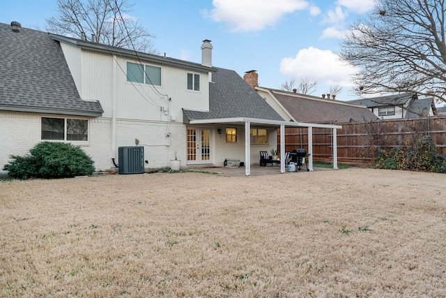 back of property featuring french doors, a patio, a yard, and central air condition unit