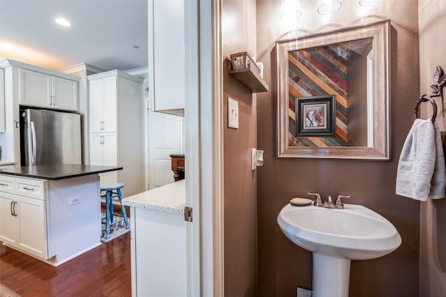 bathroom with hardwood / wood-style floors and crown molding