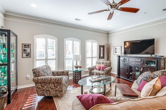 living room featuring dark wood-type flooring, crown molding, and plenty of natural light