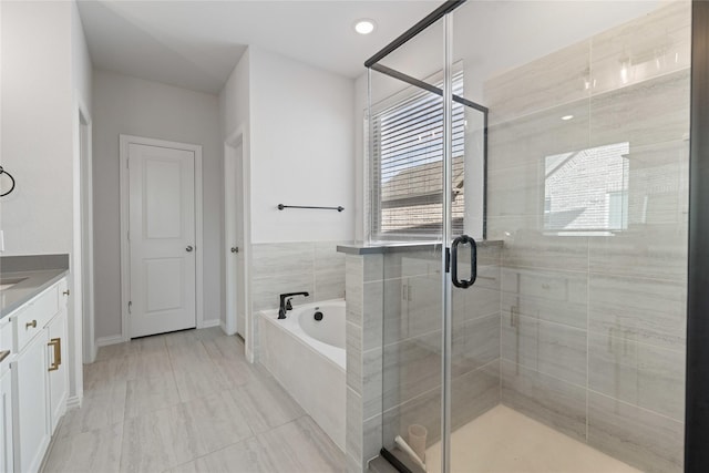 bathroom featuring plus walk in shower and vanity