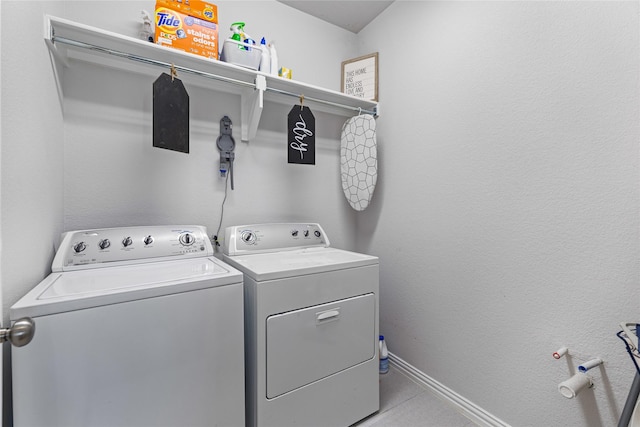 laundry room featuring washer and dryer and light tile patterned floors