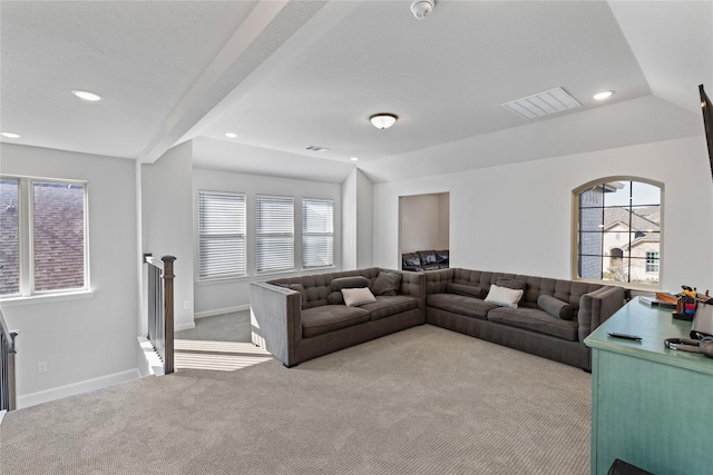 living room with lofted ceiling and light colored carpet