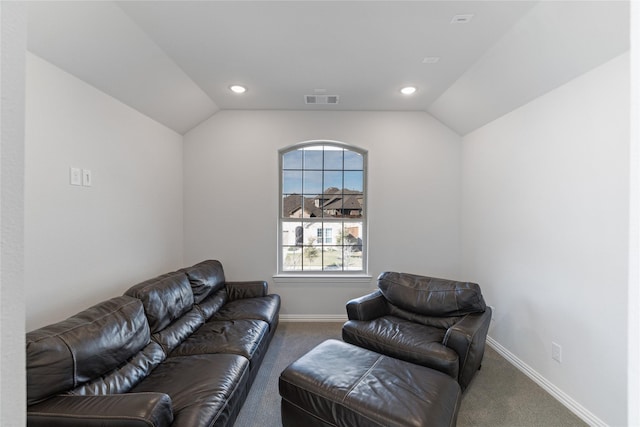 living room featuring lofted ceiling and carpet floors