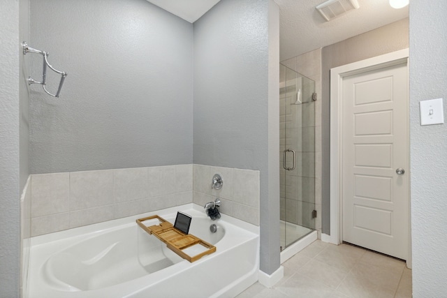 bathroom with tile patterned flooring and independent shower and bath