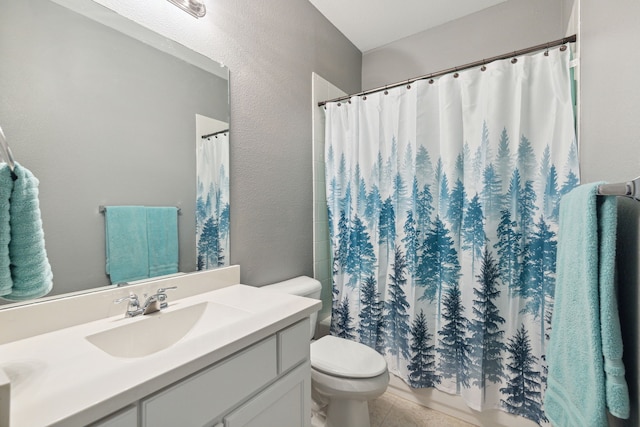 bathroom featuring toilet, vanity, and a shower with shower curtain