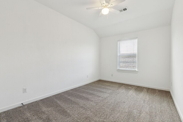 carpeted empty room with ceiling fan and lofted ceiling