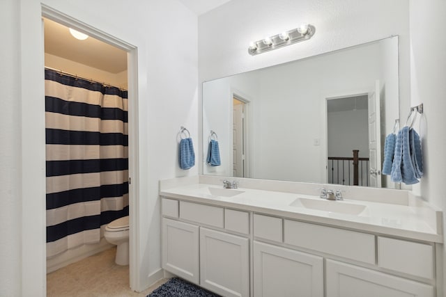 bathroom with curtained shower, toilet, vanity, and tile patterned flooring