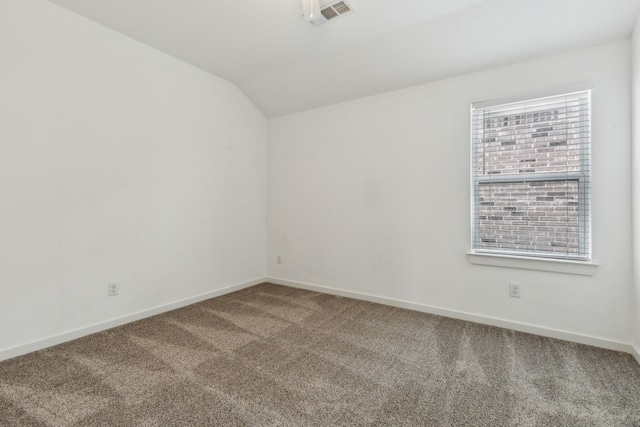 carpeted empty room with lofted ceiling