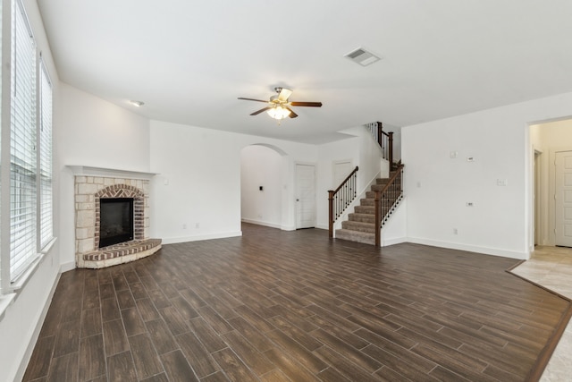 unfurnished living room featuring ceiling fan and a fireplace