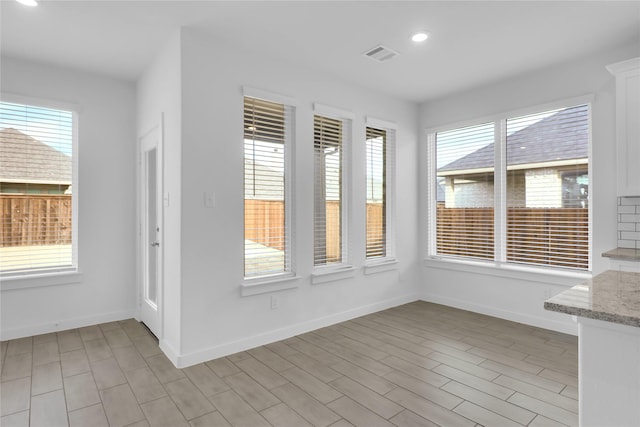 unfurnished dining area with light hardwood / wood-style flooring and plenty of natural light