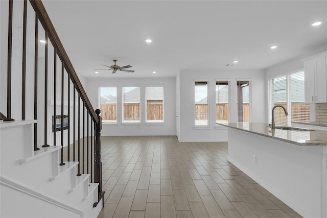 interior space with sink and ceiling fan