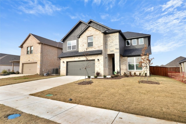 view of front of house with a garage, a front lawn, and central AC unit