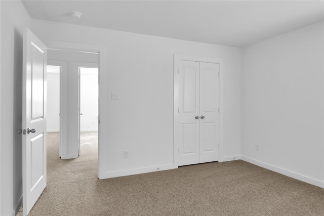 unfurnished bedroom featuring carpet floors and a closet