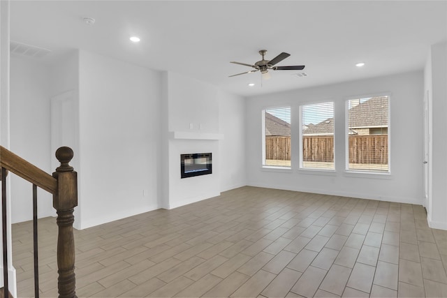 unfurnished living room with ceiling fan