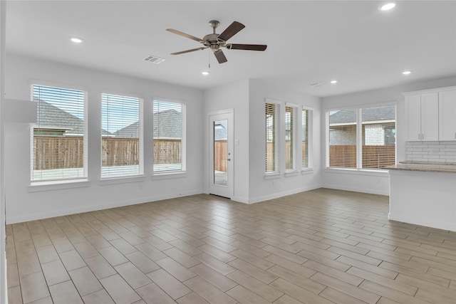 unfurnished living room with ceiling fan and light hardwood / wood-style floors