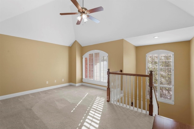 interior space featuring ceiling fan, light carpet, and vaulted ceiling