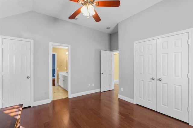 unfurnished bedroom featuring vaulted ceiling, ceiling fan, dark hardwood / wood-style floors, and connected bathroom