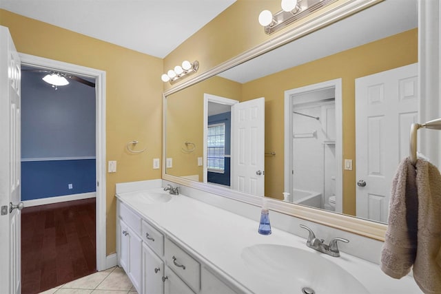 bathroom with toilet, tile patterned floors, and vanity